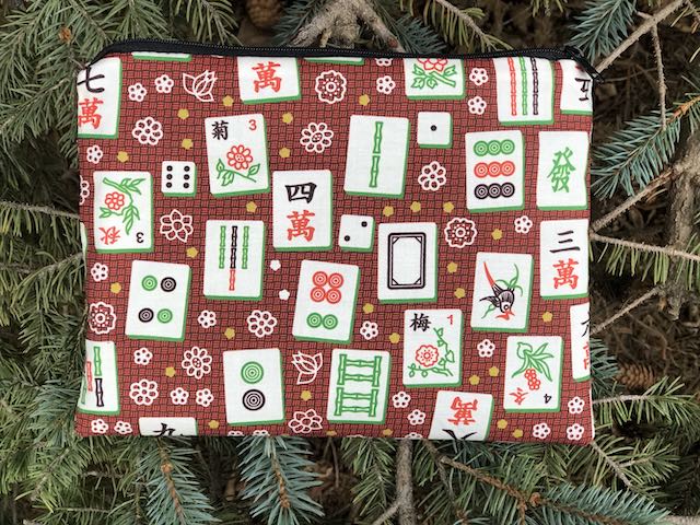 Mahjong tiles on red Mahjongg card and coin purse, The Slide Mahjong tiles on red Mahjongg card and coin purse, The Slide