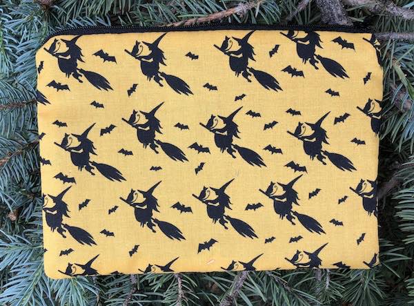 witches and cats on broomsticks yellow zippered bag
