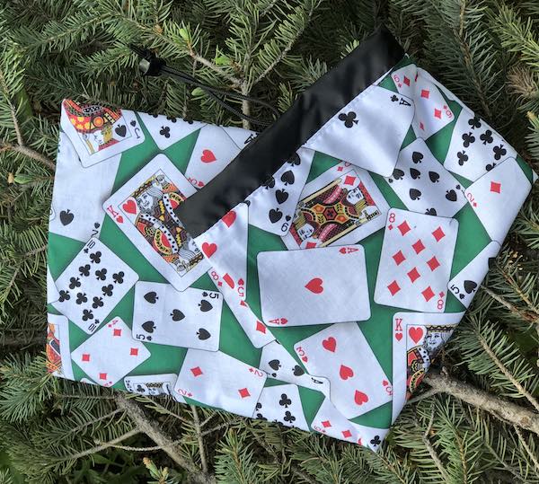 Cards on green drawstring bag for canasta racks and card spinner, Rummikub racks and tiles,  the Racker Jr
