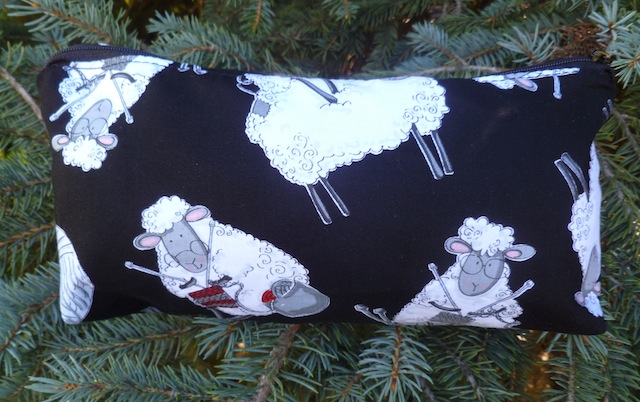 Knitting sheep on black flat bottom bag, The Zini